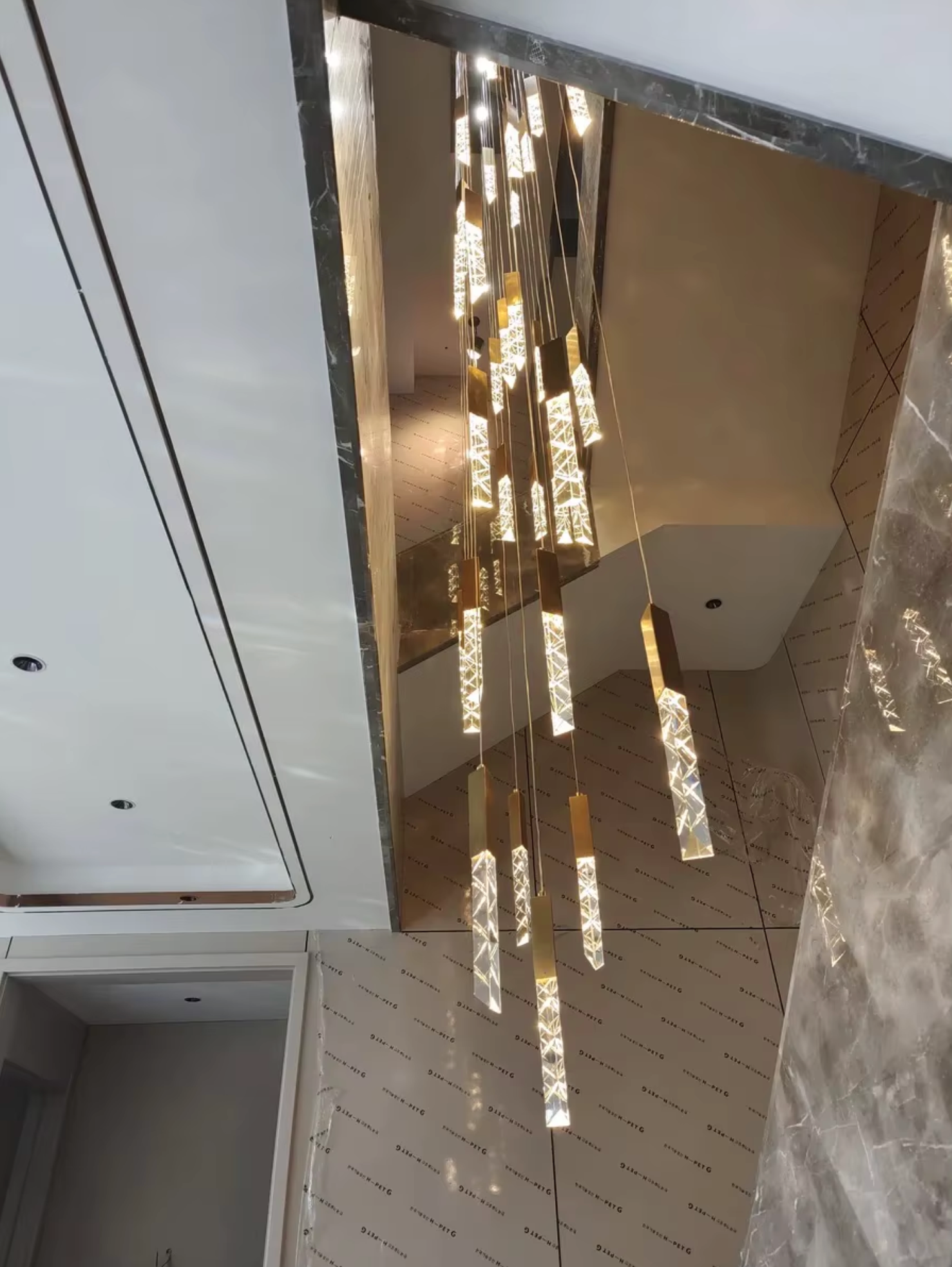 cluster gold led pendants on staircase 