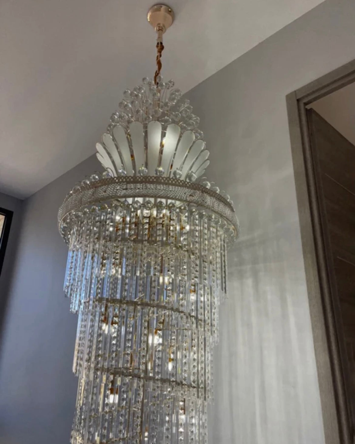 Adjustable gold crystal chandelier designed for high ceilings and staircases