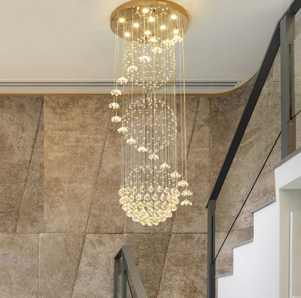 Cascading crystal chandelier designed for high ceilings and large spaces