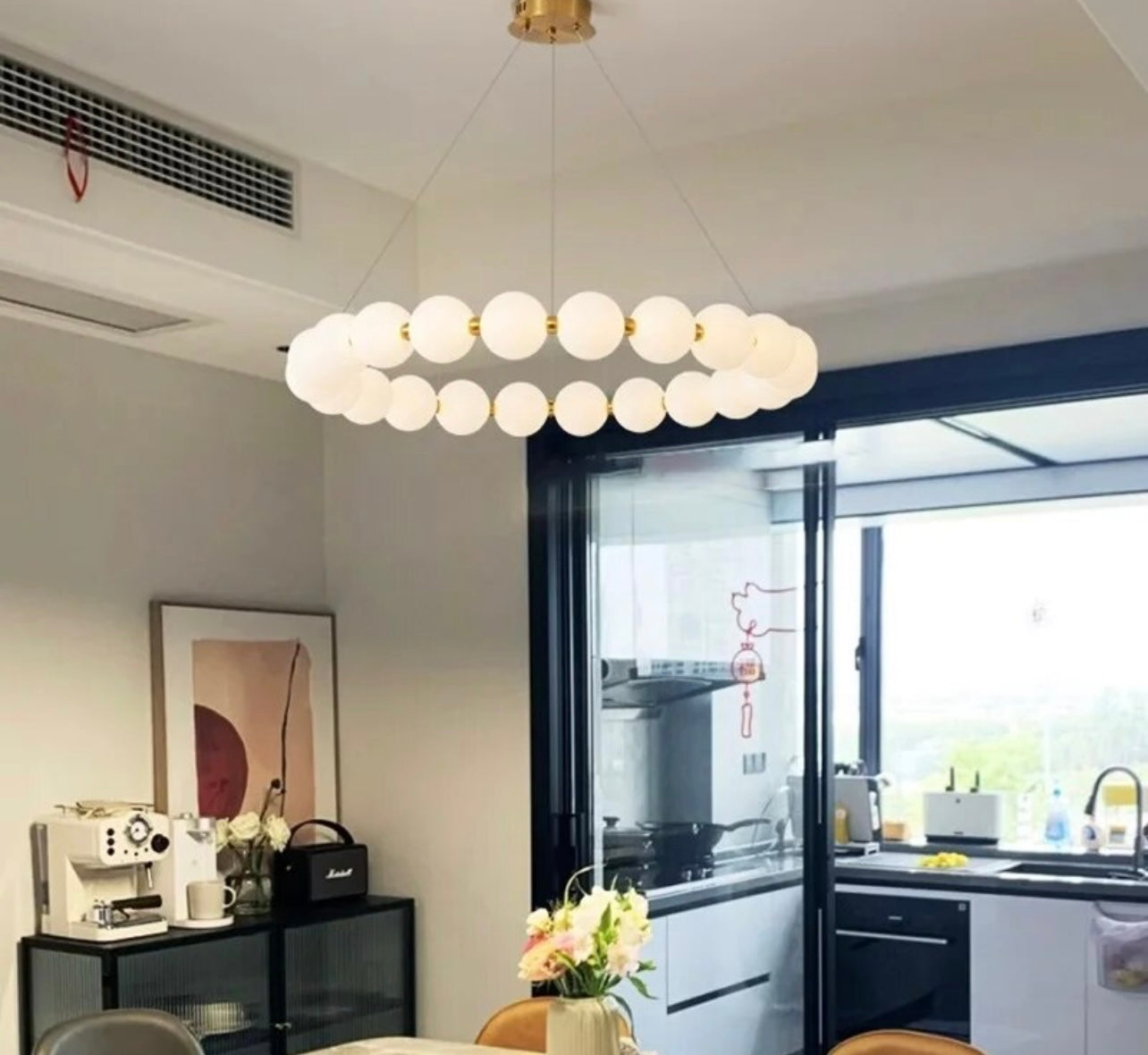 Pearl-inspired pendant light with cascading orbs in a stylish interior