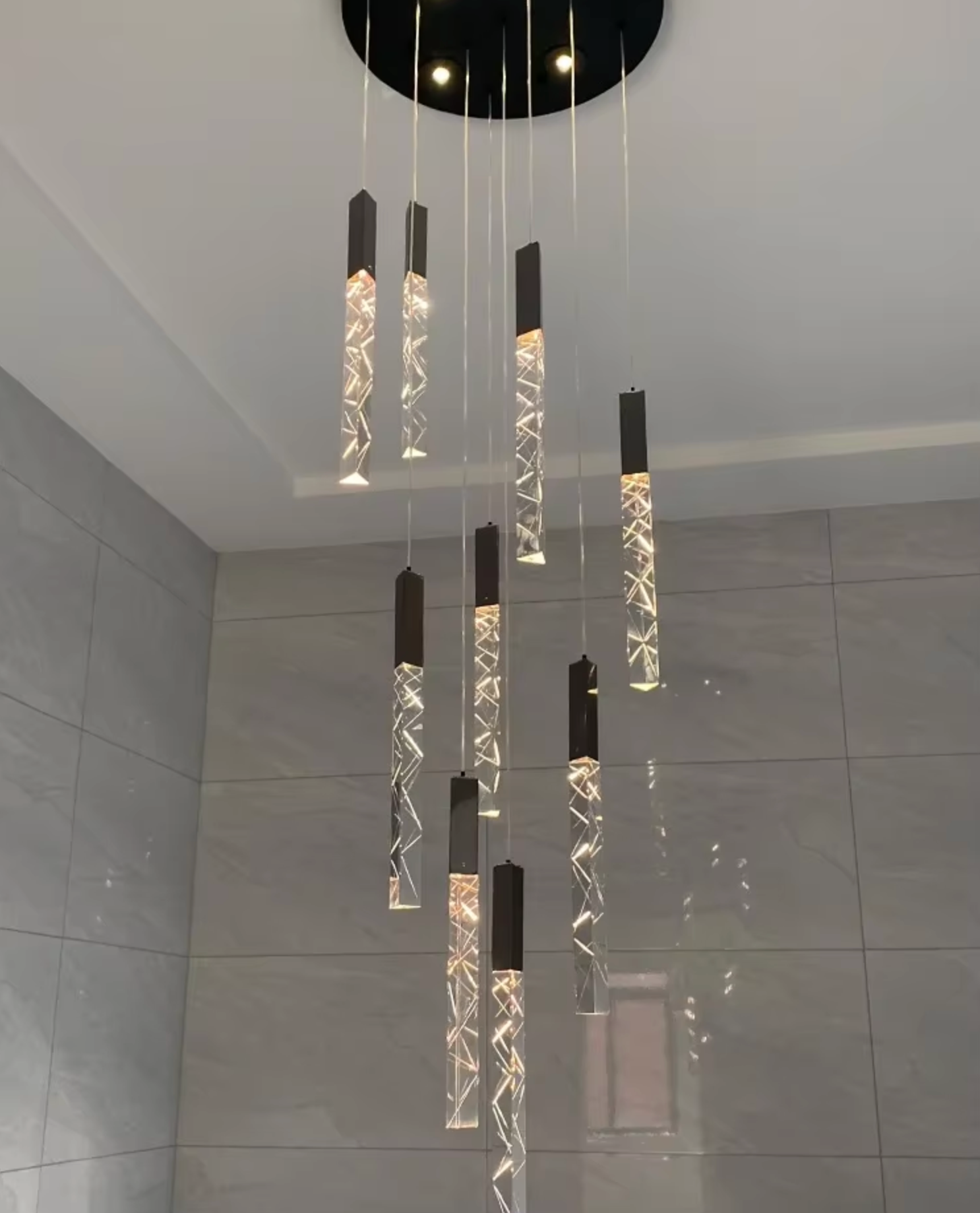 Elegant modern LED chandelier in gold finish, perfect for stairwells and entryways.