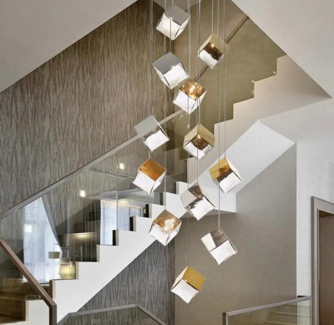 Geometric ice cube lamps illuminating a high-ceilinged staircase