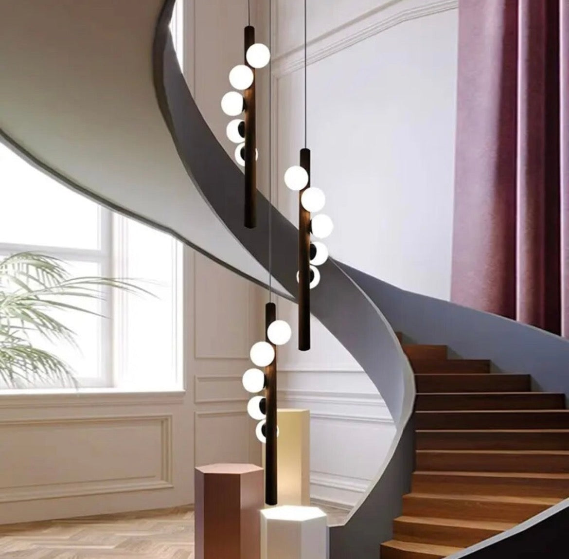 Hanging spiral ball staircase light with a modern cascading design