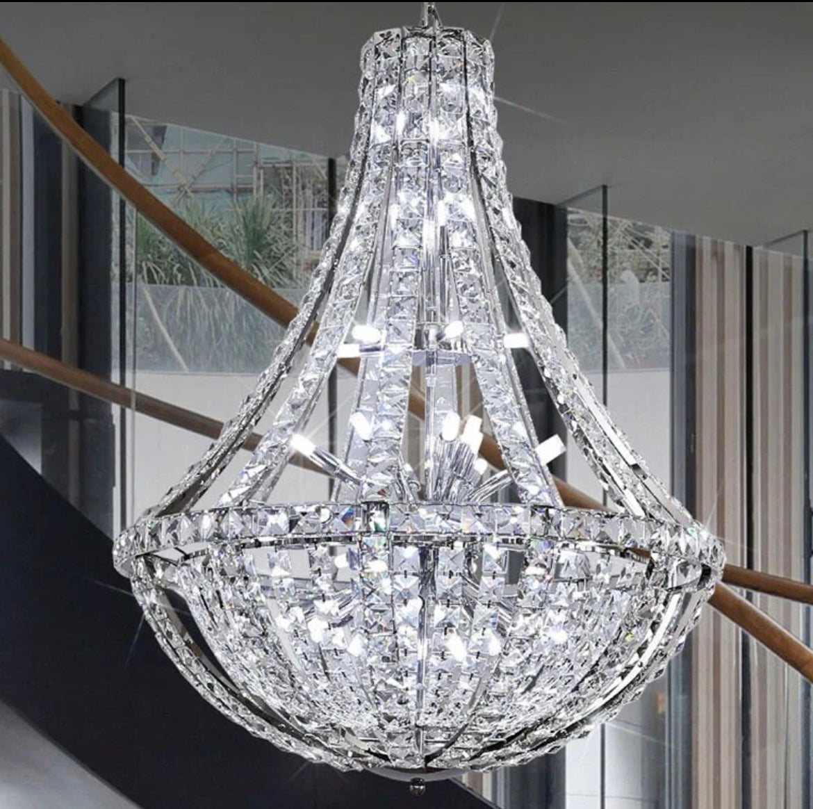 Hollow rhombus crystal pendant chandelier illuminating a modern staircase