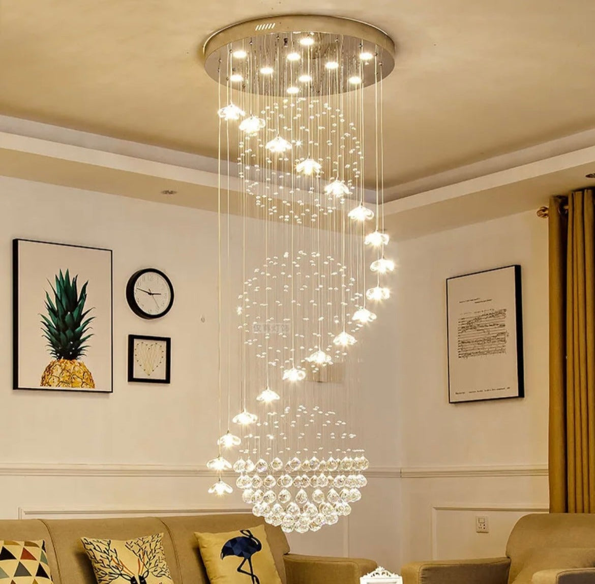 Long hanging lustre crystal chandelier illuminating a grand staircase