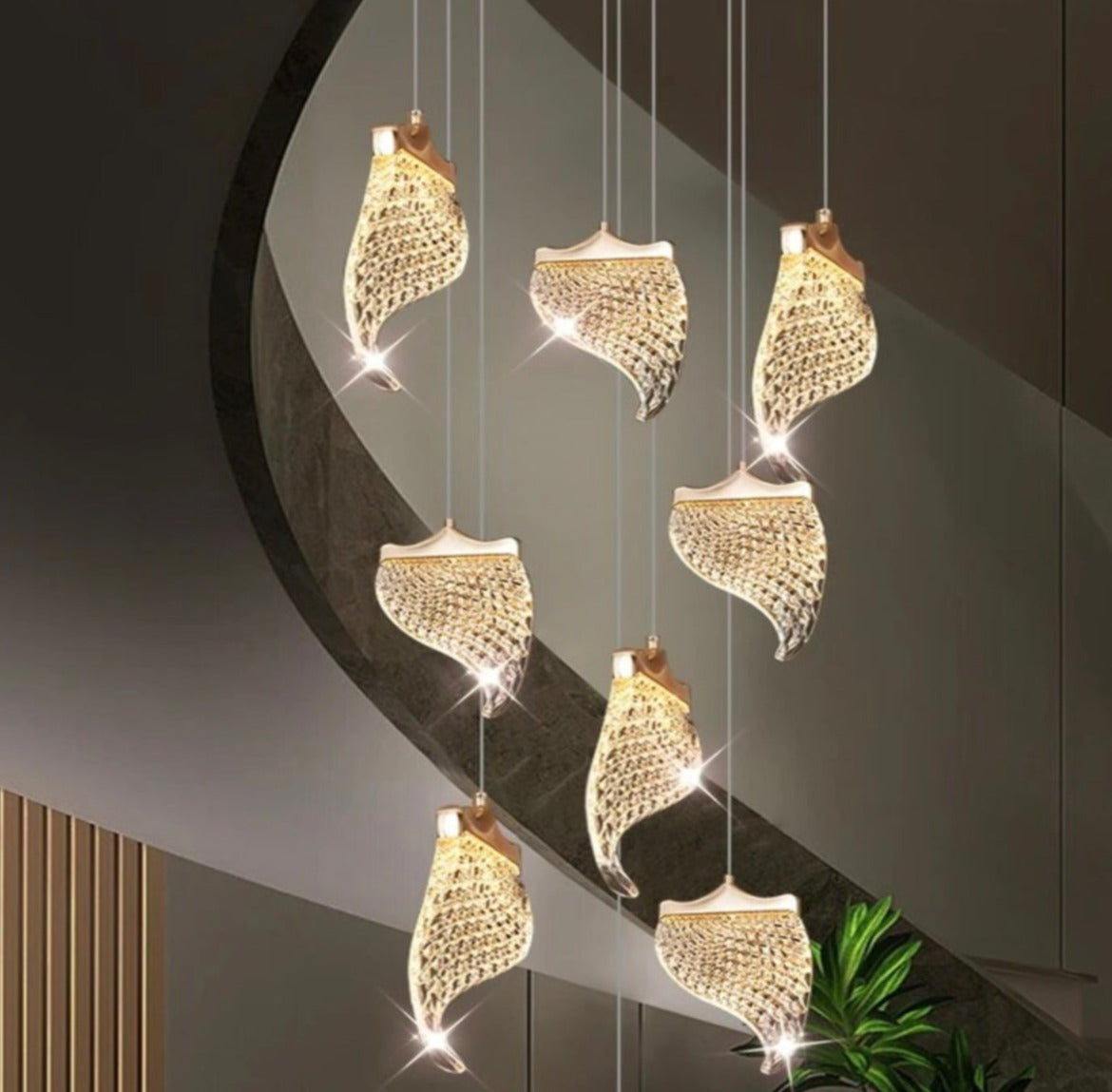 Luxury gold scaled chandelier creating a striking focal point on a staircase